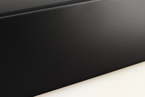 Close up of a used Denon RCD-N10 Network CD Receiver in a black finish showing light scratches on left side