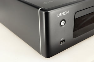 Front left corner of a used Denon RCD-N10 Network CD Receiver in a black finish