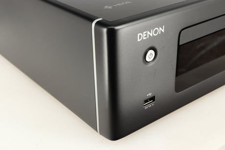 Front left corner of a used Denon RCD-N10 Network CD Receiver in a black finish