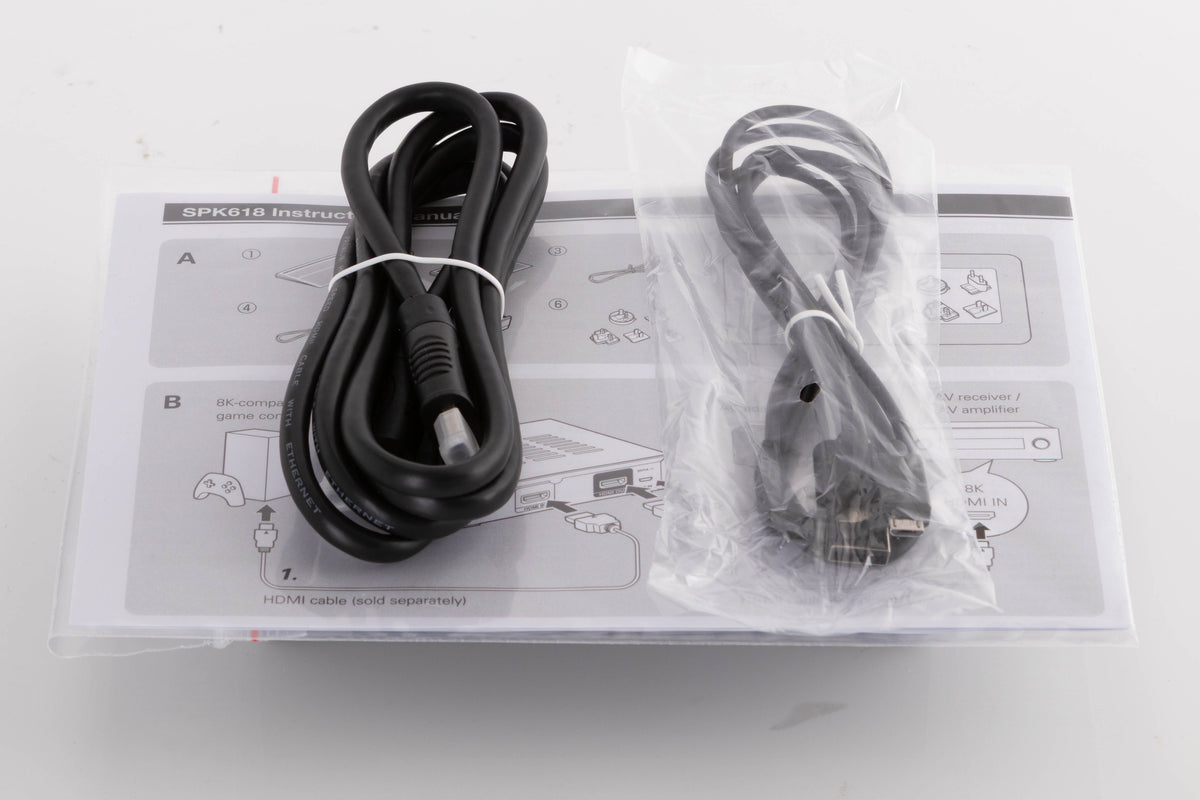 Top of a used Denon SPK618 HDMI Adaptor in a Black finish showing Manual, USB Cable and HDMI Cable