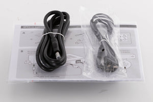 Top of a used Denon SPK618 HDMI Adaptor in a Black finish showing Manual, USB Cable and HDMI Cable
