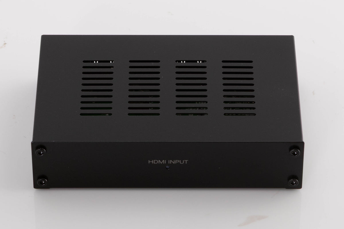 Top of a used Denon SPK618 HDMI Adaptor in a Black finish