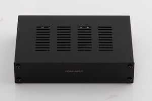 Top of a used Denon SPK618 HDMI Adaptor in a Black finish