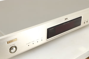 Close up of a used Denon TU-1800 DAB/FM Tuner in a silver finish showing some of the fascia