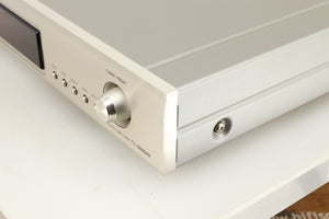 Front right-corner of a used Denon TU-1800 DAB/FM Tuner in a silver finish 