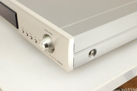 Front right-corner of a used Denon TU-1800 DAB/FM Tuner in a silver finish 