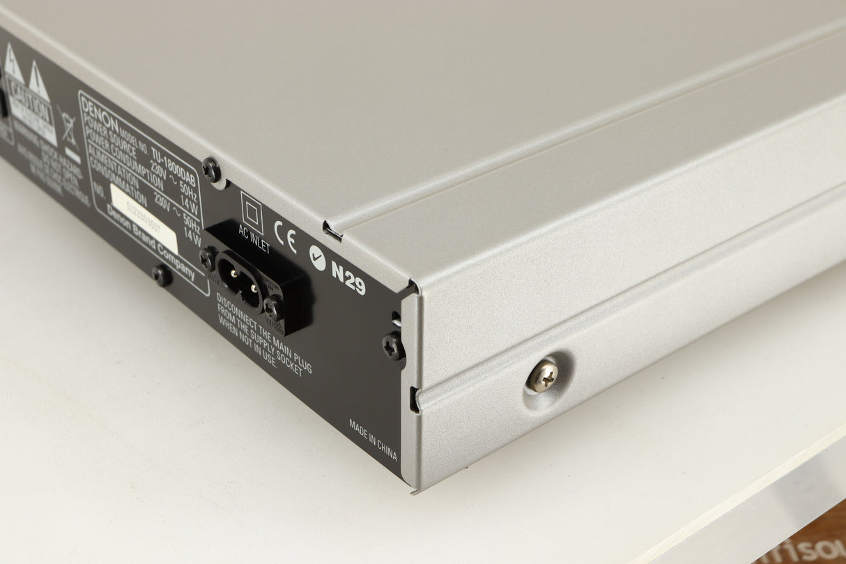 Rear left corner of a used Denon TU-1800 DAB/FM Tuner in a silver finish 