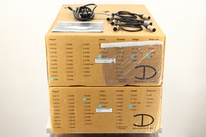 Boxes of a used Densen B-475 CD Player and a 2NRG PSU in Albino finish showing mains cable, manual, and connecting cables 