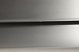 Close up view of a used Densen 2NRG PSU in Albino finish showing a scratch on the right side edge