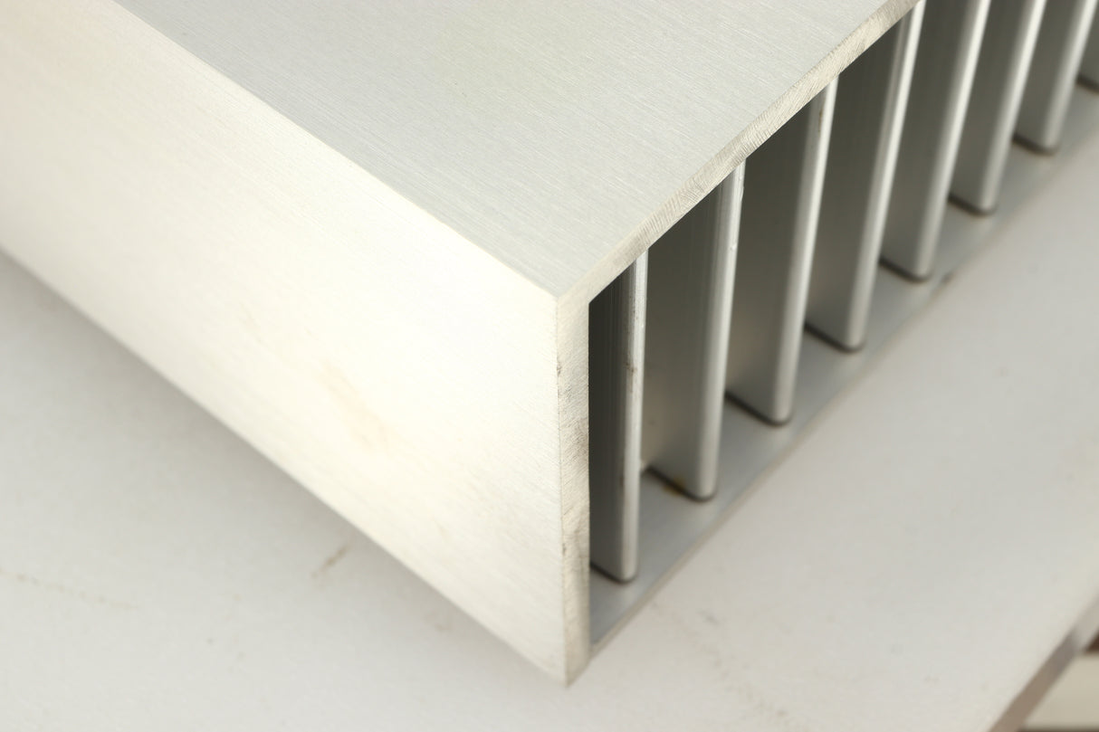 Close up of a used Densen B350Plus Monoblock Power Amplifier in a silver finish showing marking on front right corner