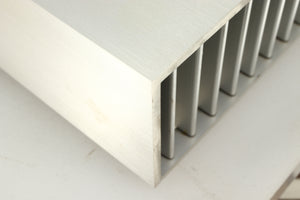 Close up of a used Densen B350Plus Monoblock Power Amplifier in a silver finish showing marking on front right corner