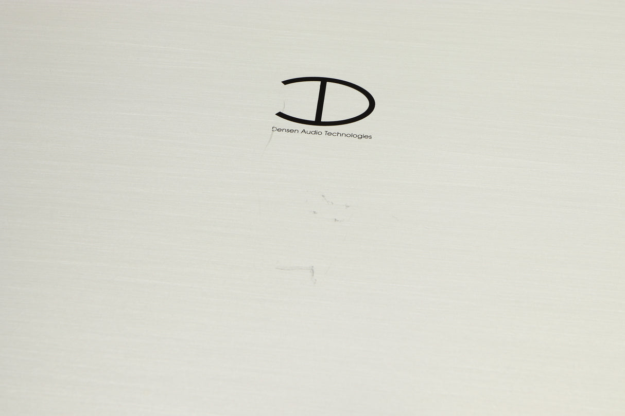 Close up of a used Densen B350Plus Monoblock Power Amplifier in a silver finish showing scratches on top