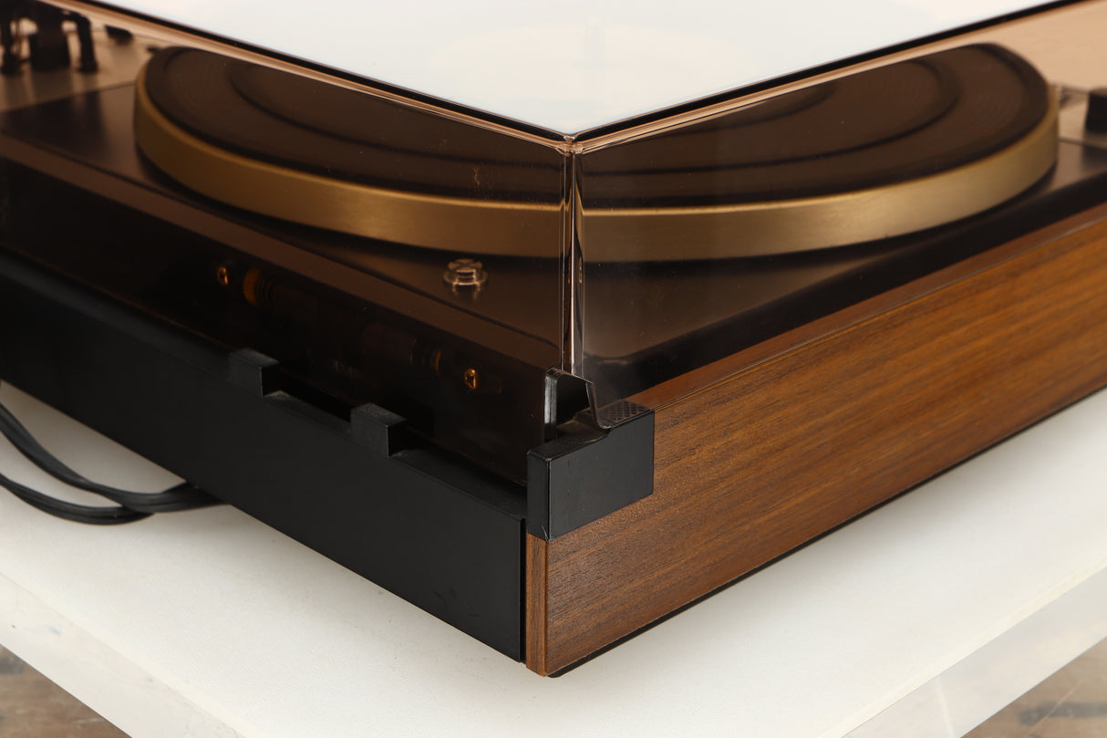 Rear left corner of a used Dual 601 Turntable / Goldring 1042 Cartridge in a walnut finish 