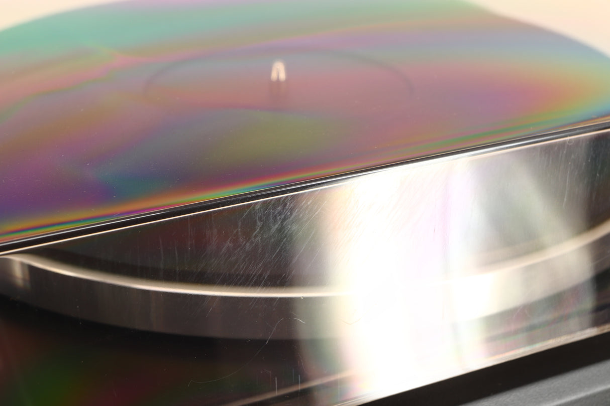 Close up of a used Dual CS 505-4 Turntable in a black finish showing multiple scratches on the back of the lid