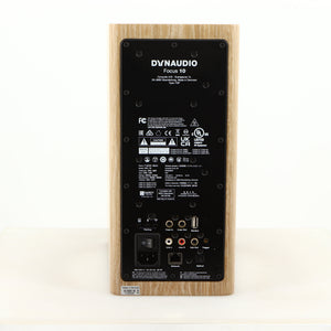 Rear view of a used Dynaudio Focus 10 Standmount Speaker in a blonde finish showing Mains Input, Network Input, Optical Input, Phono Outputs and USB Input