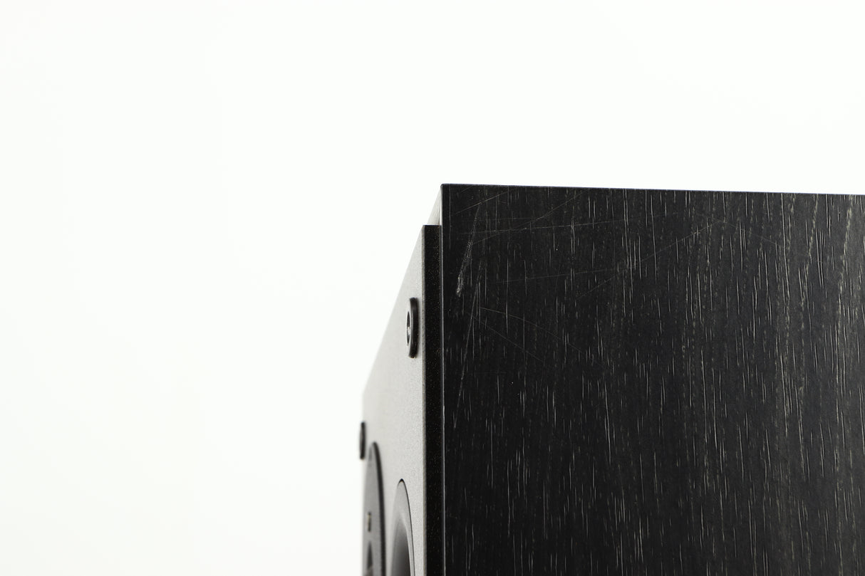 Close up of a used Dynaudio Audience 7 Standmount Speaker in a black finish showing scratching on right side