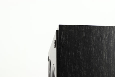 Close up of a used Dynaudio Audience 7 Standmount Speaker in a black finish showing scratching on right side