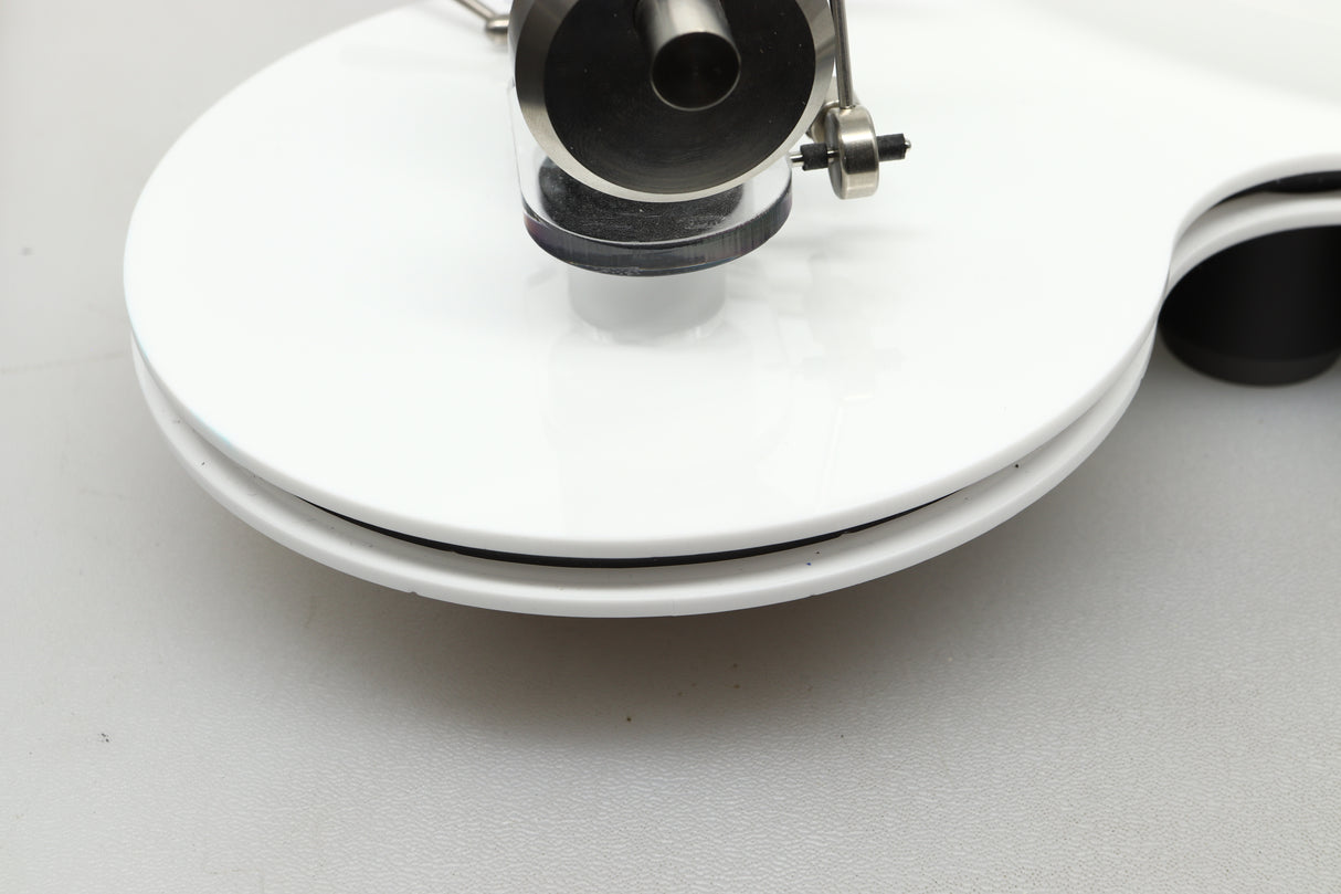 Close up view of a used Edwards Audio Apprentice Turntable in White finish showing some small dents on the side