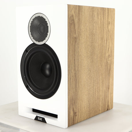 Front right corner of a used ELAC DBR62 Standmount Speaker in a light oak finish