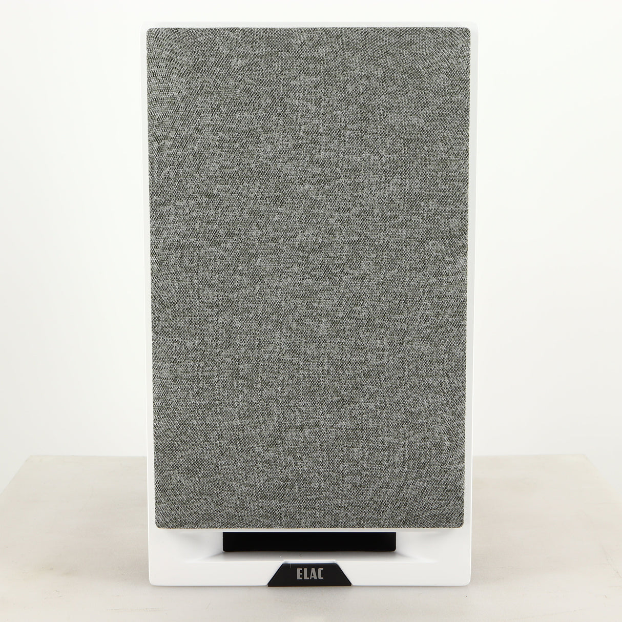 Front view of a used ELAC DBR62 Standmount Speaker in a light oak finish showing grille