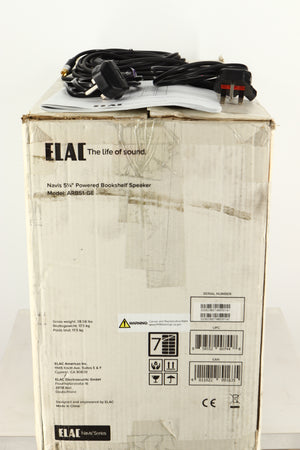 Box of a used pair of ELAC Navis B51 Active Standmount Speakers in Gloss Ebony Emara finish showing mains cables, and interconnects