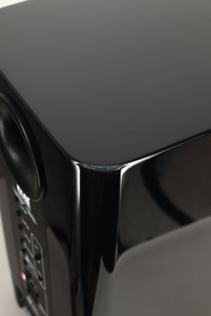Close up view of a used ELAC Navis B51 Active Standmount Speaker in Gloss Ebony Emara finish showing marks under the top coat
