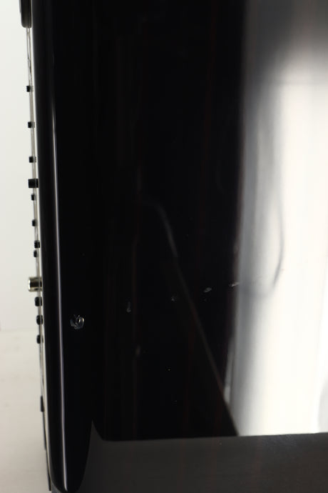 Close up view of a used ELAC Navis B51 Active Standmount Speaker in Gloss Ebony Emara finish showing marks under the top coat