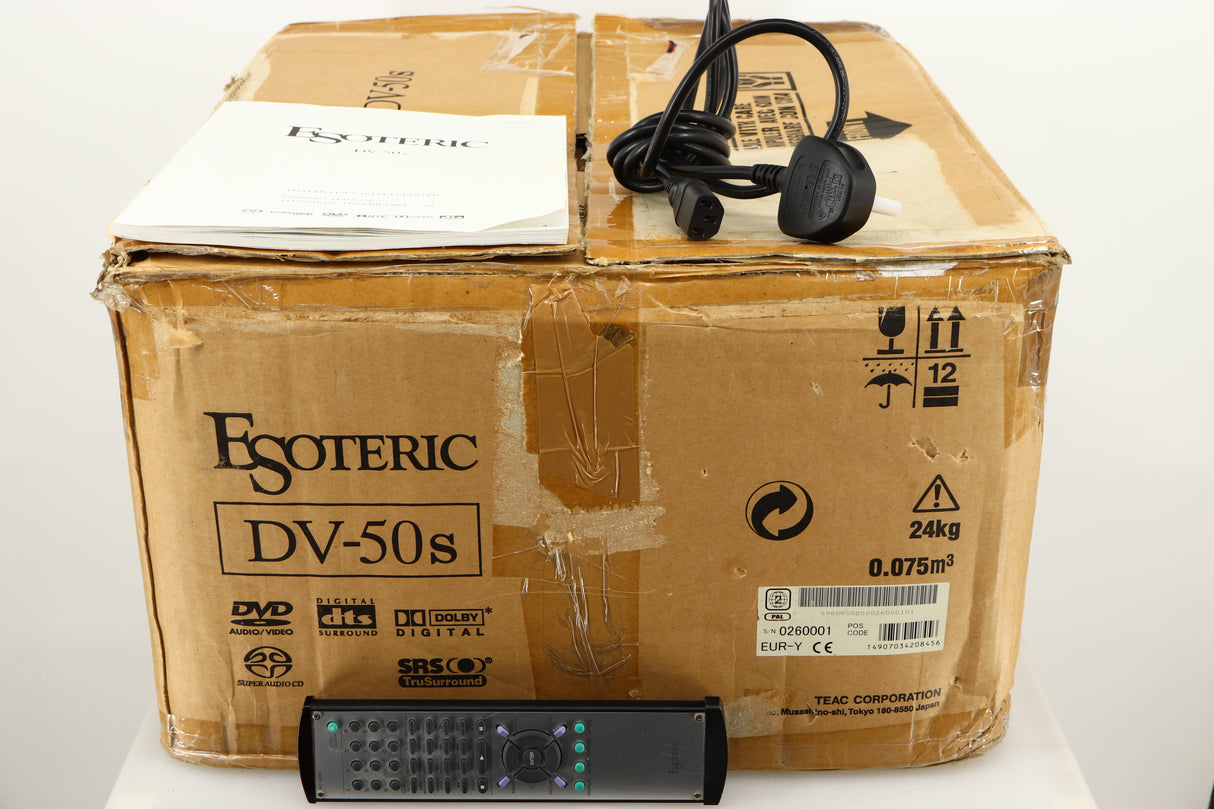 Box for a used Esoteric DV-50s DVD Player in a silver finish showing Mains Cable, Manual, Remote