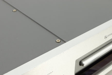 Close up of a used Esoteric DV-50s DVD Player in a silver finish showing some scratches on top edge