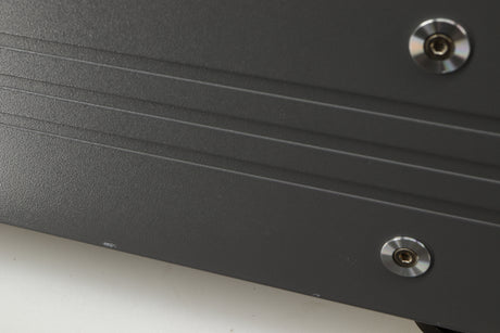 Close up of a used Esoteric DV-50s DVD Player in a silver finish showing white marks on left side 
