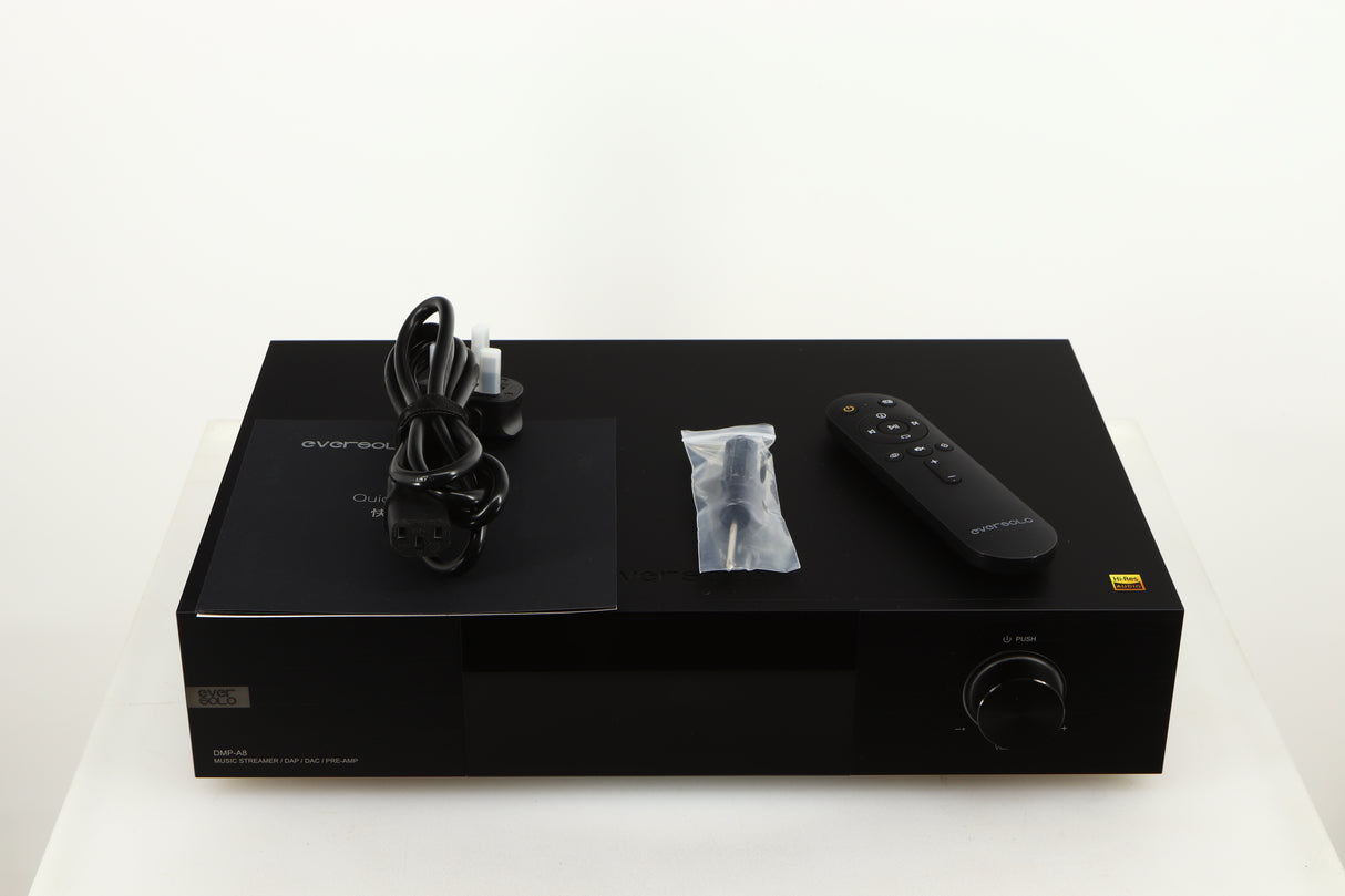 Top of a used Eversolo DMP A8 Streamer / Pre Amplifier / DAC in a black finish showing Mains Cable, Manual, Screwdriver and Remote 