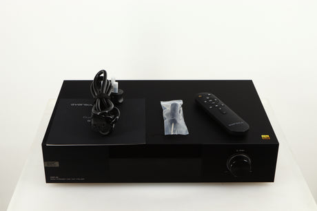 Top of a used Eversolo DMP A8 Streamer / Pre Amplifier / DAC in a black finish showing Mains Cable, Manual, Screwdriver and Remote 