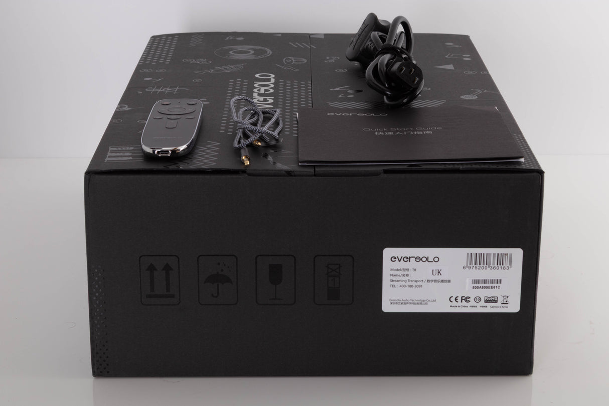 Box of a used Eversolo T8 Streaming Transport with mains cable, remote, and 3.5mm cable