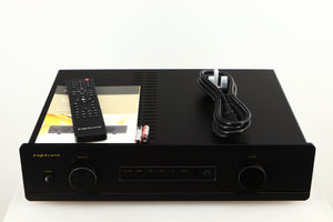 Top of a used Exposure 3510 Integrated Amplifier in a black finish showing Remote, Mains Cable, 2x Batteries and Manual