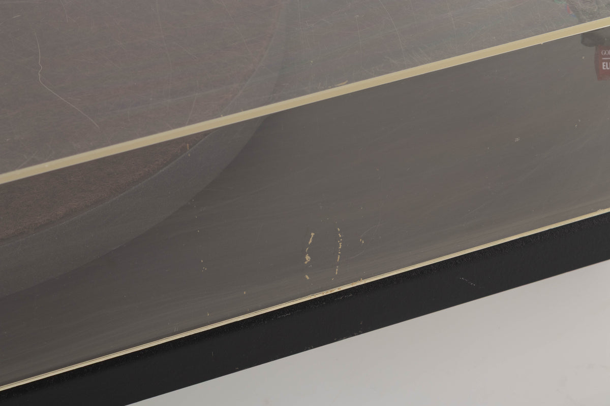 Close up of a used Goldring GR1.2 Turntable showing scratching on lid