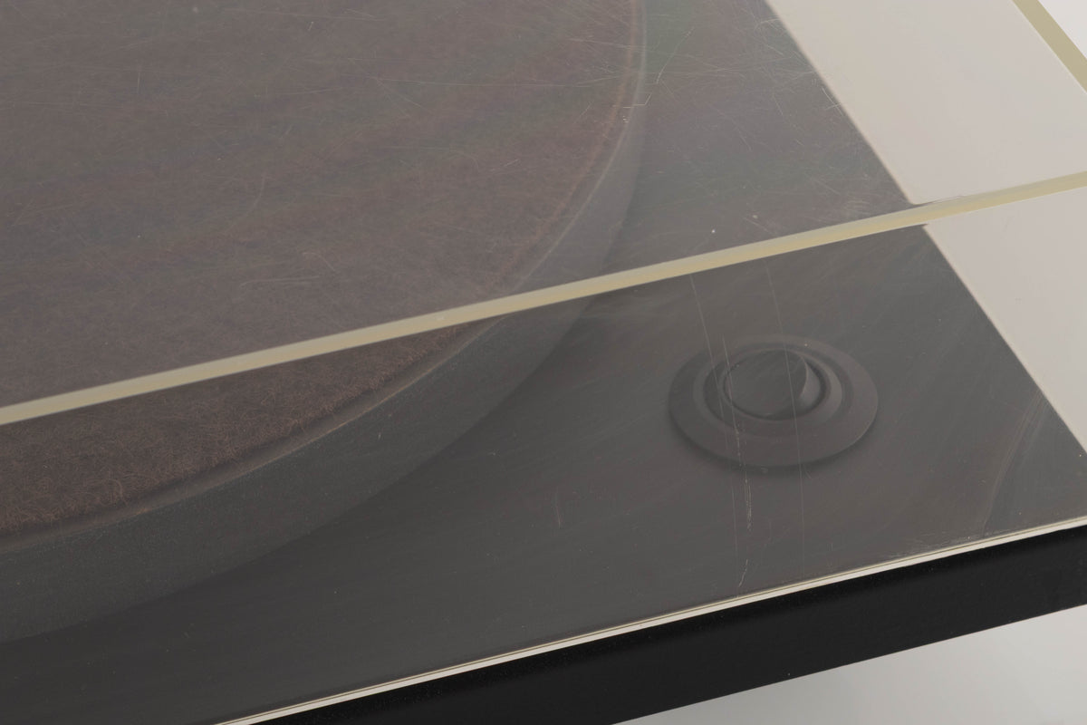 Close up of a used Goldring GR1.2 Turntable showing scratching on lid