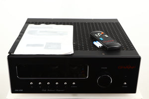 Top of a used Graaf GM50 Integrated Amplifier in a black finish showing Manual, Remote and 2x Batteries