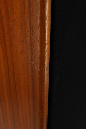 Close up of a used Harbeth Super HL5 Plus 40th Anniversary Standmount Speaker in a walnut finish showing a scratch on the front left corner