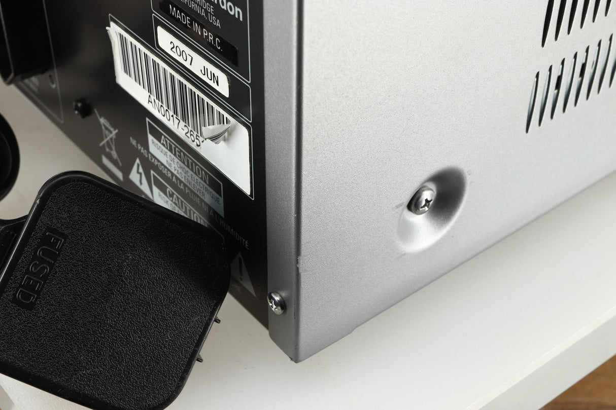 Close up of a used Harman Kardon 3380 Receiver in a silver finish showing more scratching