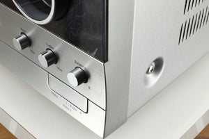Close up of a used Harman Kardon 3380 Receiver in a silver finish showing more scratching