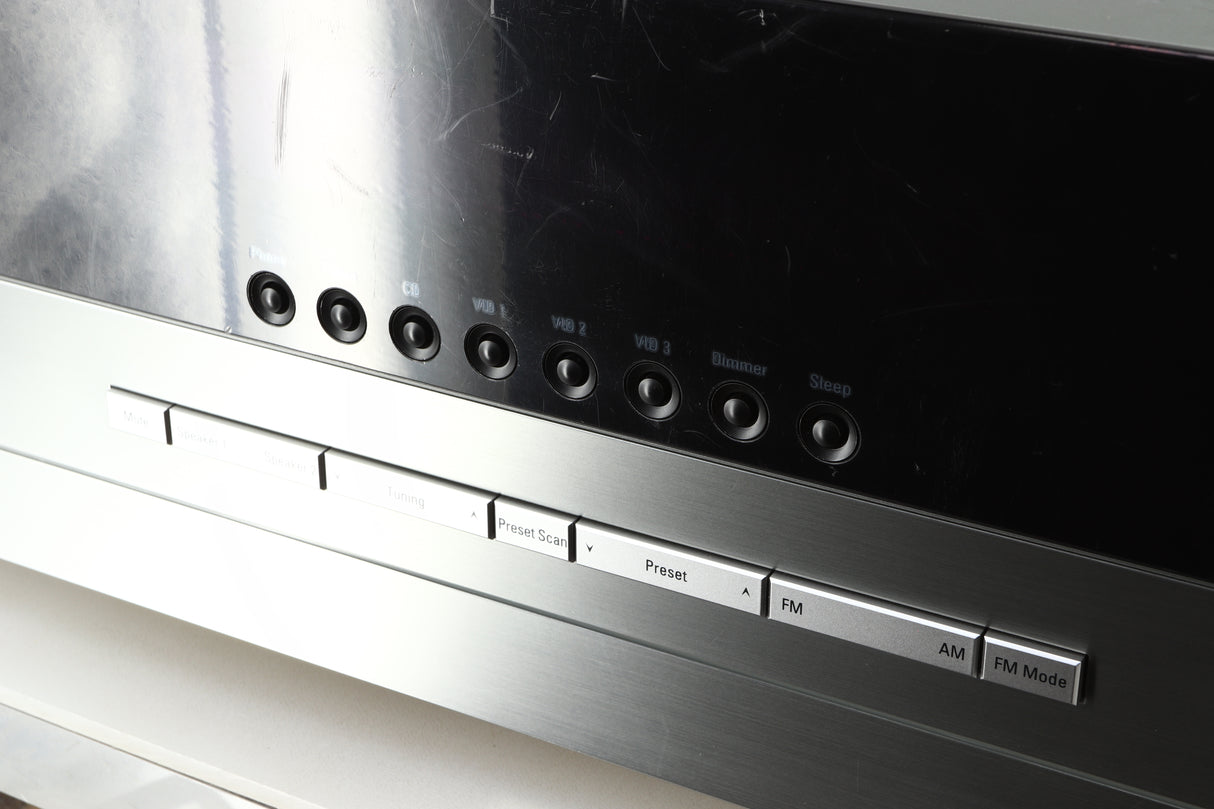 Close up of a used Harman Kardon 3380 Receiver in a silver finish showing scratching on the screen 