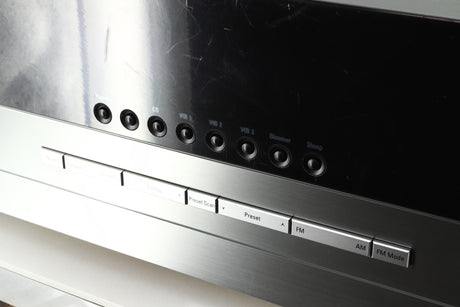 Close up of a used Harman Kardon 3380 Receiver in a silver finish showing scratching on the screen 