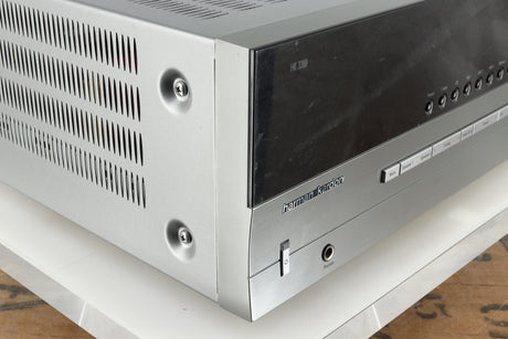 Front left corner of a used Harman Kardon 3380 Receiver in a silver finish