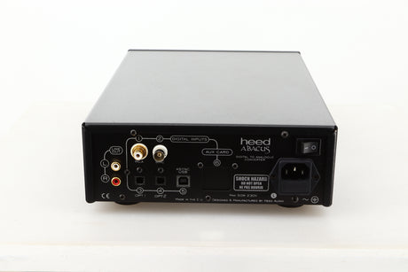 Rear view of a used Heed Abacus DAC in Black finish showing RCA outputs, RCA, BNC, optical, USB, and mains inputs 