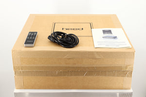 Box of a used Heed Thesis Delta CD Transport in Black finish showing mains cable, manual, and remote 