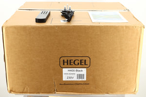 Box of a used Hegel H400 Streaming Amplifier in Black finish showing remote, manual, and mains cable