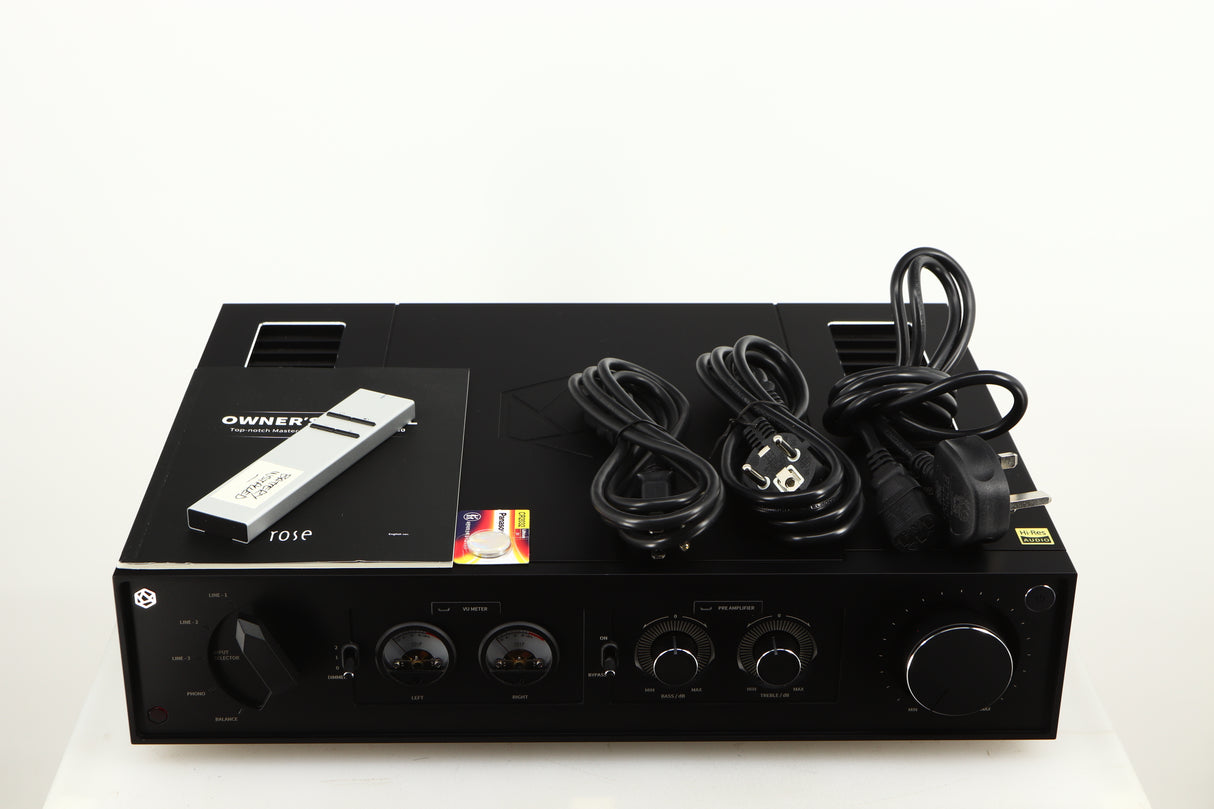 Top of a used HiFi ROSE RA280 Integrated Amplifier in a black finish showing Remote, Manual, Battery, Mains Cable and Schuko Cable