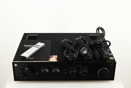 Top of a used HiFi ROSE RA280 Integrated Amplifier in a black finish showing Remote, Manual, Battery, Mains Cable and Schuko Cable