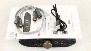Top of a used iFi Audio Zen Air Can Headphone Amplifier showing USB Cable, Manual and Interconnect Cable