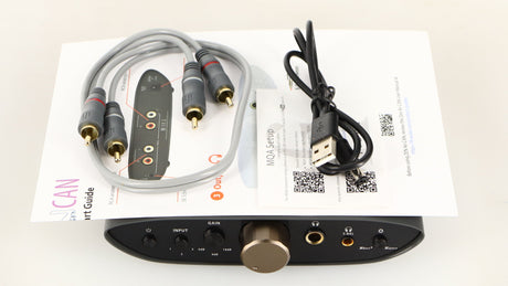 Top of a used iFi Audio Zen Air Can Headphone Amplifier showing USB Cable, Manual and Interconnect Cable
